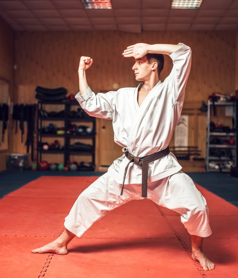 Martial arts master on fight training in gym